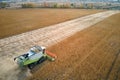 Aerial view of combine harvester working during harvesting season on large ripe wheat field. Agriculture concept Royalty Free Stock Photo