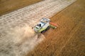 Aerial view of combine harvester working during harvesting season on large ripe wheat field. Agriculture concept Royalty Free Stock Photo