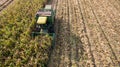 Aerial view Combine harvesters are working in Corn fields. Harvesting fields skyline Aerial.