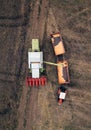 Aerial view of combine pouring harvested corn grains into traile Royalty Free Stock Photo