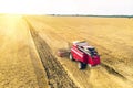 Aerial view on the combine working on the large wheat field. Haymaking and harvesting in early autumn on the field. Tractor mows