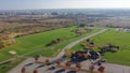 Aerial view community recreational center with grassy lawn soccer fields, colorful autumn leaves and plateau farm prairie leading Royalty Free Stock Photo