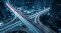 Aerial view of a busy highway interchange at night with light trails traffic city Royalty Free Stock Photo