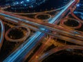 Aerial view of a complex highway interchange at night with traffic light trails isolated on white background Royalty Free Stock Photo