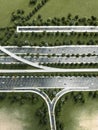 Aerial view of complex road interchange with highway lanes, green landscape and trees Royalty Free Stock Photo