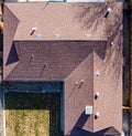 Aerial roof top inspection with damaged shingles and rusty pipes. Royalty Free Stock Photo