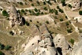 Aerial view of cone-shaped mountains with caves inside in the town of Uchisar, in Cappadocia, Turkey Royalty Free Stock Photo