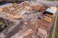 Aerial view of the construction site during the building of a wooden house from thick beams of sawn trees with construction