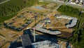 Aerial view of a construction site in the countryside area. Video. Large building territory surrounded by green pine