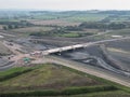 Aerial view of a construction site with groundworks and a culvert in the foreground