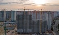 Aerial view of construction site of residential area buildings with cranes at sunset from above Royalty Free Stock Photo