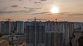 Aerial view of construction site of residential area buildings with cranes at sunset from above, urban skyline Royalty Free Stock Photo