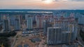 Aerial view of construction site of residential area buildings with cranes at sunset from above, urban skyline Royalty Free Stock Photo