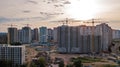 Aerial view of construction site of residential area buildings with cranes at sunset from above, urban skyline Royalty Free Stock Photo