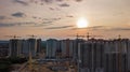 Aerial view of construction site of residential area buildings with cranes at sunset from above, urban skyline Royalty Free Stock Photo