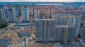 Aerial view of construction site of residential area buildings with cranes at sunset from above, urban skyline Royalty Free Stock Photo