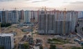 Aerial view of construction site of residential area buildings with cranes at sunset from above Royalty Free Stock Photo