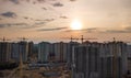 Aerial view of construction site of residential area buildings with cranes at sunset from above Royalty Free Stock Photo