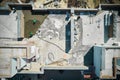 Aerial view of construction site with workers screeding floor on the roof