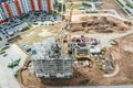 Aerial view of construction site with yellow crane and building materials Royalty Free Stock Photo