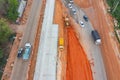 Aerial view of construction tractor car, bulldozer, or backhoe digging road or street in traffic transportation and agriculture