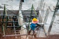 Authentic construction worker busy on the positioning of formwork frames in construction site