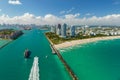 Aerial view of container ship entering in Miami harbor main channel near South Beach. Luxurious hotels and apartment Royalty Free Stock Photo