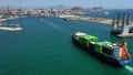 Aerial view of the container ship JSP Rover, maneuvering in the port of Alicante.