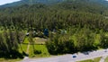 Aerial view of a country house with a garden and greenhouses surrounded by fresh air and natural green trees near Mountains in Royalty Free Stock Photo