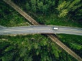 Aerial view of country road above the railway in a green summer forest Royalty Free Stock Photo