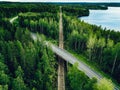 Aerial view of country road above the railway in a green summer forest Royalty Free Stock Photo