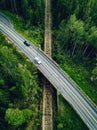 Aerial view of country road above the railway in a green summer forest Royalty Free Stock Photo