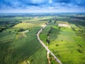 Aerial view of a country road amid fields Royalty Free Stock Photo