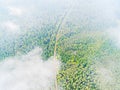 Aerial view of a country road in the forest. Beautiful landscape. Clouds over the green forest and road. Aerial bird`s eye road. Royalty Free Stock Photo