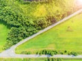 Aerial view of a country road in the forest with moving cars. Landscape. Captured from above with a drone. Aerial bird`s eye road Royalty Free Stock Photo