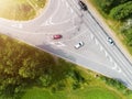 Aerial view of a country road in the forest with moving cars. Landscape. Captured from above with a drone. Aerial bird`s eye road Royalty Free Stock Photo