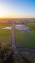 Aerial View of Country Road at Sunset with Luminous Fields Royalty Free Stock Photo