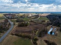 aerial view of country roads and small village with houses and lake