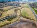 aerial view of country roads and small village with houses and lake