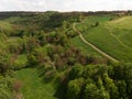 Aerial view of a countryside canyone, with dirt road and green summer hill by drone, beautiful nature concept design Royalty Free Stock Photo