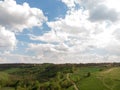 Aerial view of a countryside canyone, with dirt road and green summer hill by drone, beautiful nature concept design Royalty Free Stock Photo