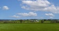 Aerial View of Countryside, with Farms, Green Crops, Trees, Borders, Barns and Silos