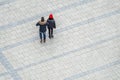 Aerial view of couple crossing the square in the city of Munich