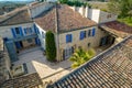 Aerial view of a courtyard in the south of France with a villa with stone walls and tiled roofs