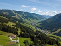Aerial view on cozy hut with mountain panorama from Hinterglemm to Saalbach in the Alps in Austria. on a sunny summer Royalty Free Stock Photo