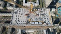 Aerial view of a crane over the skyscraper building  -construction in an urban city Royalty Free Stock Photo