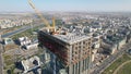 Aerial view of a crane over the skyscraper building  -construction in an urban city Royalty Free Stock Photo