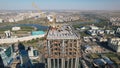 Aerial view of a crane over the skyscraper building  -construction in an urban city Royalty Free Stock Photo