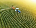 Aerial view of crop sprayer spraying pesticide on a soybean field at sunset Royalty Free Stock Photo