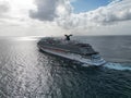 Aerial view of a cruise vessel navigating in the sea on a cloudy day